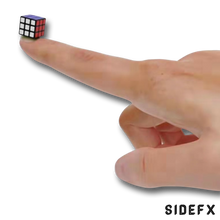 Load image into Gallery viewer, Rubiks cube on finger to show size
